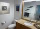 Bathroom with granite countertop, large mirror, and updated vanity at 3060 Grand Bay Blvd # 174, Longboat Key, FL 34228