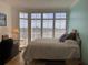 Bright bedroom with large windows, comfortable bed, and ocean views at 3060 Grand Bay Blvd # 174, Longboat Key, FL 34228