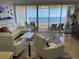 Living room with water view and comfortable seating at 3060 Grand Bay Blvd # 174, Longboat Key, FL 34228