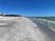 Expansive beach view with clear blue skies at 3806 Gulf Of Mexico Dr # C310, Longboat Key, FL 34228