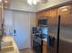 Modern kitchen with stainless steel appliances and wood cabinets at 3806 Gulf Of Mexico Dr # C310, Longboat Key, FL 34228