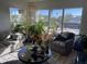 Bright living room with large windows, comfortable seating, and many plants at 3806 Gulf Of Mexico Dr # C310, Longboat Key, FL 34228