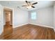 Hardwood floor bedroom with ceiling fan and access to hallway at 5340 5Th S Ave, St Petersburg, FL 33707