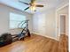 Hardwood floor bedroom with elliptical and access to hallway at 5340 5Th S Ave, St Petersburg, FL 33707