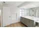 Modern bathroom with gray vanity, double sinks, and mirror at 6628 Keystone Dr, Sarasota, FL 34231