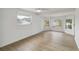 Bright bedroom with wood-look floors and multiple windows at 6628 Keystone Dr, Sarasota, FL 34231