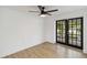 Bright bedroom with light wood floors and french doors at 6628 Keystone Dr, Sarasota, FL 34231