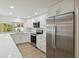 White kitchen with stainless steel appliances and quartz countertops at 6628 Keystone Dr, Sarasota, FL 34231