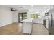 Modern white kitchen with stainless steel appliances and island at 6628 Keystone Dr, Sarasota, FL 34231