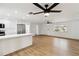 Living room with light wood floors, ceiling fan, and kitchen island at 6628 Keystone Dr, Sarasota, FL 34231