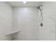 Clean shower with marble-style tile and built-in seat at 6628 Keystone Dr, Sarasota, FL 34231