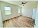 Bright bedroom with ceiling fan and wood-look flooring at 7950 Chandler Lake Ct, Hudson, FL 34667