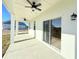 Spacious covered patio with ceiling fans and sliding glass doors at 7971 Chandler Lake Ct, Hudson, FL 34667