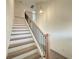 Modern staircase with light wood and dark metal accents at 7971 Chandler Lake Ct, Hudson, FL 34667