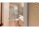 Well-lit bathroom with a glass-enclosed shower and single sink vanity at 1710 Curry Ave # 42, Nokomis, FL 34275