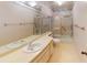 Bathroom with double vanity, tub, and shower at 1710 Curry Ave # 42, Nokomis, FL 34275
