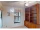 Bedroom featuring a built-in bookcase and a bright window, creating a cozy and functional space at 1710 Curry Ave # 42, Nokomis, FL 34275