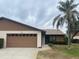 Front view of a single-story home with attached garage and palm tree at 1710 Curry Ave # 42, Nokomis, FL 34275