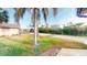 Landscaped front yard with palm tree and view of street at 1710 Curry Ave # 42, Nokomis, FL 34275