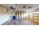 Spacious garage with ample storage shelving and ceiling fan at 1710 Curry Ave # 42, Nokomis, FL 34275