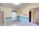 Kitchen with white cabinets, refrigerator, and breakfast nook at 1710 Curry Ave # 42, Nokomis, FL 34275