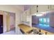 Kitchen with white cabinets, double sink, and view of living room at 1710 Curry Ave # 42, Nokomis, FL 34275