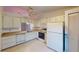 Bright kitchen features white cabinets, appliances, and tile flooring for a clean aesthetic at 1710 Curry Ave # 42, Nokomis, FL 34275
