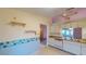 Kitchen with white cabinets, dishwasher, and view to living room at 1710 Curry Ave # 42, Nokomis, FL 34275
