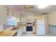 Bright kitchen featuring white appliances and ample cabinet space at 1710 Curry Ave # 42, Nokomis, FL 34275