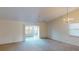 Bright living room with vaulted ceiling, carpet flooring, and access to a sunroom at 1710 Curry Ave # 42, Nokomis, FL 34275