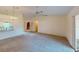 Living room with high ceiling, carpet, and open concept to kitchen at 1710 Curry Ave # 42, Nokomis, FL 34275