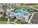 An aerial view of the community pool and recreation center, surrounded by palm trees and lush landscaping at 17150 Savory Mist Cir, Bradenton, FL 34211