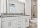 Modern bathroom with double vanity featuring granite counters and tile floors and shower at 18024 Cherished Loop, Bradenton, FL 34211