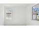 Bright bedroom featuring white walls, tile flooring, and dual windows at 18024 Cherished Loop, Bradenton, FL 34211