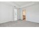 Spacious bedroom with plush carpet, a door to an ensuite bathroom, and bright natural light at 18024 Cherished Loop, Bradenton, FL 34211