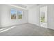 Bright bedroom with soft carpet, large windows, and an open doorway to the bathroom area at 18024 Cherished Loop, Bradenton, FL 34211