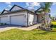 Beautiful home with a two car garage, manicured lawn and brick walkway at 18024 Cherished Loop, Bradenton, FL 34211