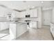 Modern kitchen with white cabinets, an island and stainless steel appliances at 18024 Cherished Loop, Bradenton, FL 34211