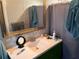 Bathroom featuring a vanity with ample countertop space and a large mirror at 246 176Th E Ave, Redington Shores, FL 33708