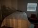 Bedroom with a comfortable bed and natural light from the window at 246 176Th E Ave, Redington Shores, FL 33708
