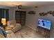 Cozy living room with neutral tones, a ceiling fan, and entertainment options at 246 176Th E Ave, Redington Shores, FL 33708