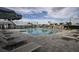 Lounge poolside at the community pool, with umbrellas, tables, and chairs for relaxing at 4719 Cassonade Cv, Bradenton, FL 34211