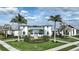 Exterior view of a modern clubhouse featuring two palm trees on each side of the walkway at 4720 Sweet Retreat Run, Bradenton, FL 34211