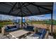 Outdoor patio with wicker couches, stone coffee table, and covered gazebo near playground at 4720 Sweet Retreat Run, Bradenton, FL 34211