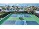 Aerial view of tennis courts, swimming pool, and clubhouse within a gated community at 4720 Sweet Retreat Run, Bradenton, FL 34211