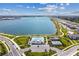 Breathtaking aerial view of a lakefront community featuring a pool, playground, and scenic walking trails at 7526 Backlight Ln, Sarasota, FL 34240