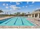Sparkling community pool featuring marked swimming lanes and comfortable lounge chairs at 7526 Backlight Ln, Sarasota, FL 34240