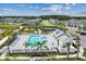 Aerial view showcasing a sparkling pool, tennis court, and playground amenities in a Gathering-friendly community at 7526 Backlight Ln, Sarasota, FL 34240