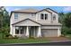Two-story house with gray siding, brown roof, and a two-car garage at 7556 Nighthawk Dr, Sarasota, FL 34241