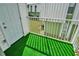 Private balcony with artificial turf and railing at 7450 35Th N St # 1604, Pinellas Park, FL 33781
